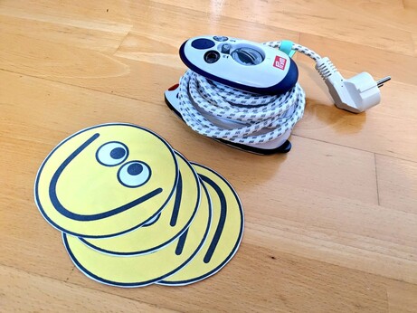 A mini flatiron and cut out smiley faces